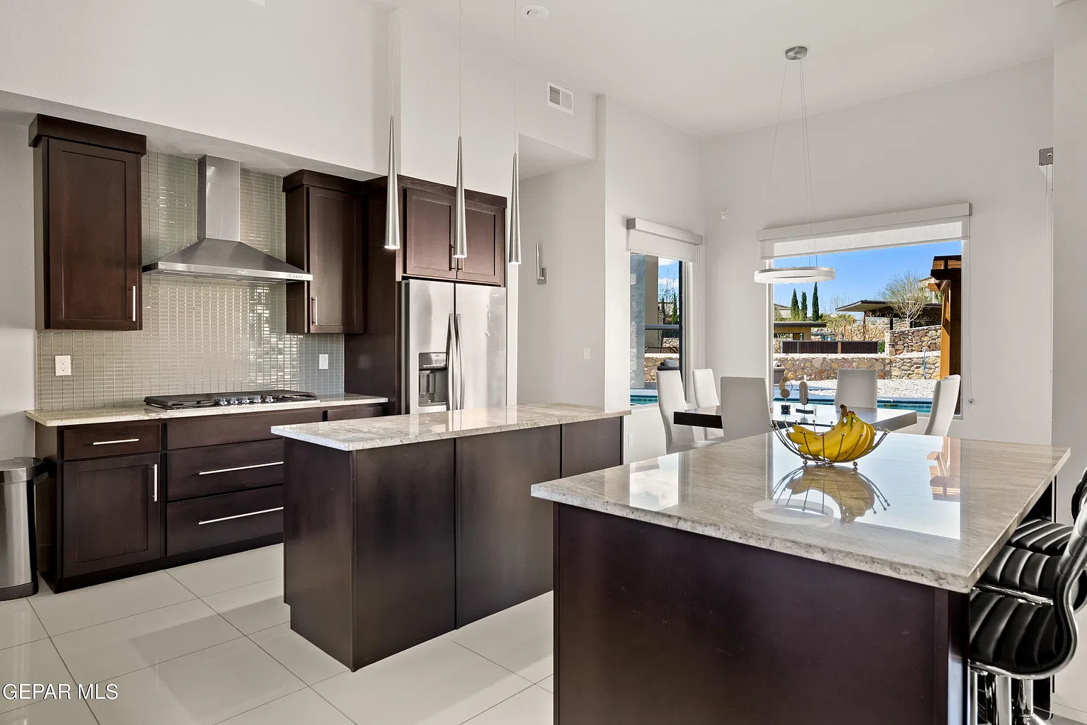 Original kitchen photo facing the islands and dining area